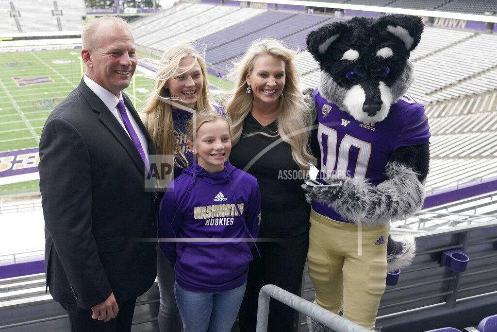 Ted S. Warren Kalen DeBoer, left, poses for a photo with his wife Nicole, and his daughters Alexis and Avery along with Harry, the Washington mascot, Tuesday, Nov. 30, 2021, at Husky Stadium, following a news conference in Seattle, to introduce DeBoer as the new head NCAA college football coach at the University of Washington. DeBoer has spent the past two seasons as head football coach at Fresno State. (AP Photo/Ted S. Warren)