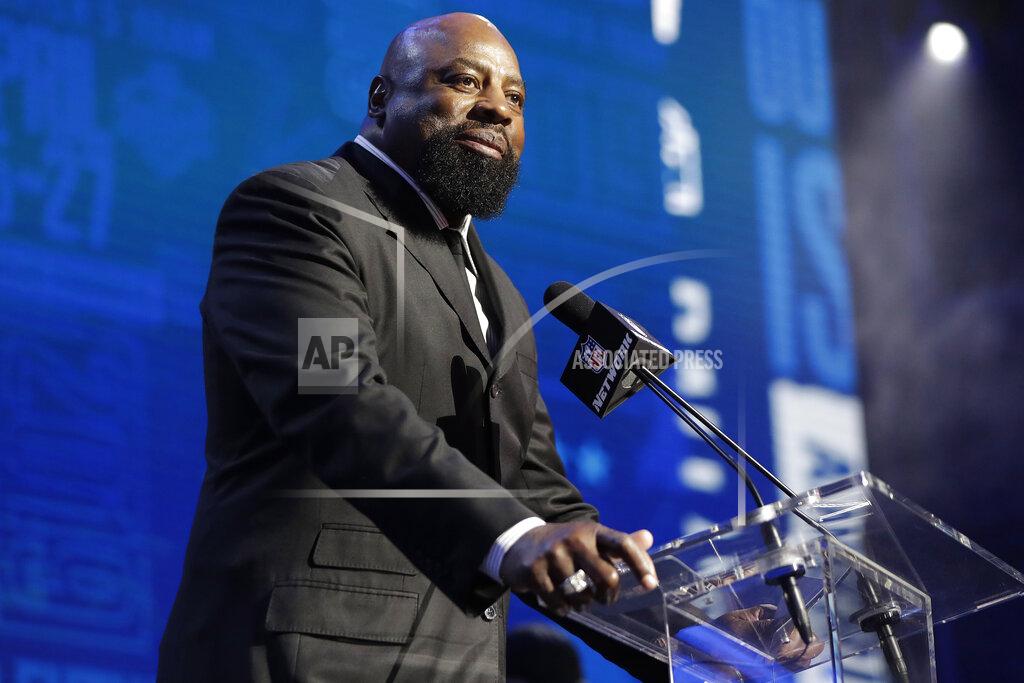 Former Dallas Cowboys player Ed Jones announces the Cowboys pick as Central Florida defensive tackle Trysten Hill during the second round of the NFL football draft, Friday, April 26, 2019, in Nashville, Tenn. (AP Photo/Mark Humphrey)
