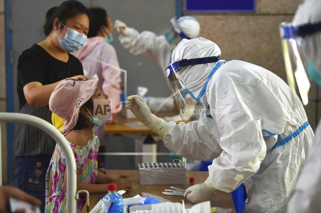 Uncredited A nurse takes swab samples in the new rounds of Covid-19 testing in Nanjing in eastern China's Jiangsu province Monday, Aug. 2, 2021. China's worst coronavirus outbreak since the start of the pandemic a year and a half ago escalated Wednesday, Aug. 4, 2021 with dozens more cases around the country, the sealing-off of one city and the punishment of its local leaders. (Chinatopix Via AP)