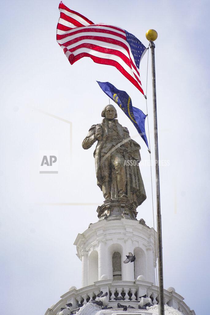 Keith Srakocic U.S. and county flags fly near the refurbished statue of George Washington and dome of the county courthouse in Washington, Pa., March 28, 2022 Many county improvements have been made possible because the funding made available through shale gas drilling in the county. (AP Photo/Keith Srakocic)