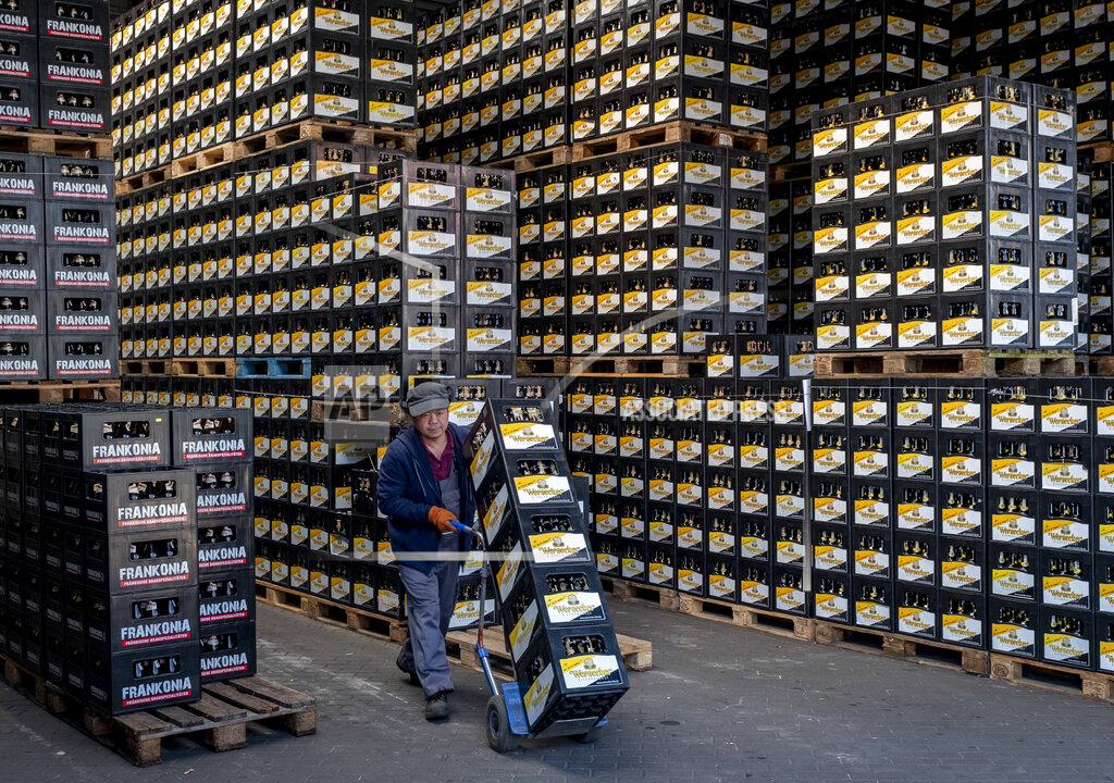 Michael Probst In this , Friday, April 17, 2020 photo worker of the "Wernecker brewery" transports beer crates in Werneck, Germany. Due to the impact of the coronavirus the traditional brewery has to close 400 years after its foundation. (AP Photo/Michael Probst)