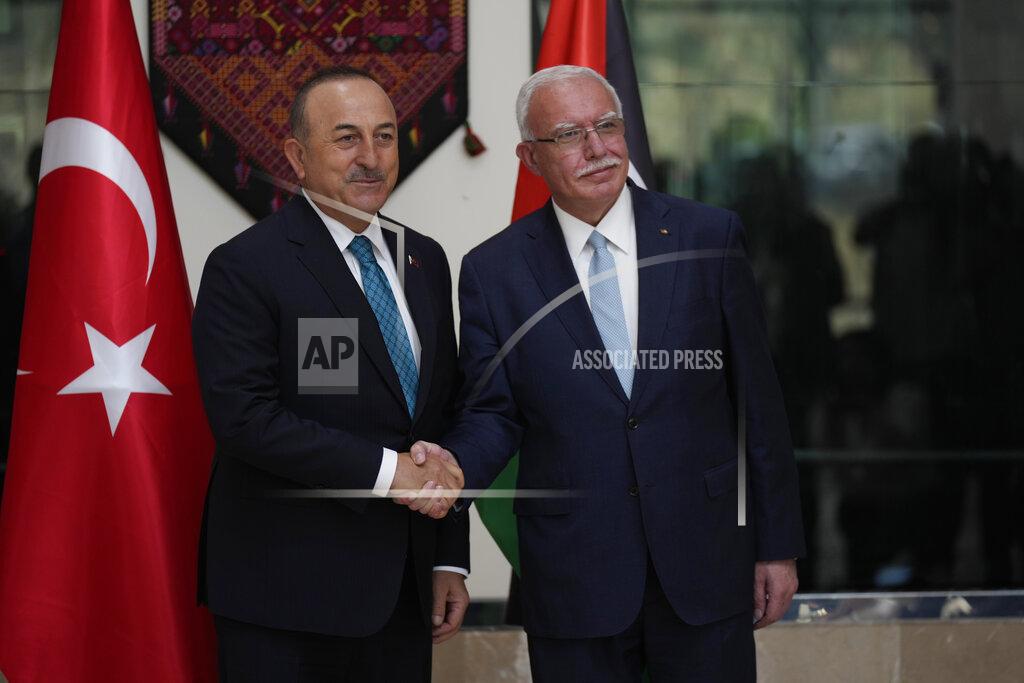 Majdi Mohammed Turkish Foreign Minister Mevlut Cavusoglu, left, shakes hands with Palestinian Foreign Minister Riad al-Malki, in the West Bank town of Ramallah, Tuesday, May 24, 2022. (AP Photo/Majdi Mohammed)