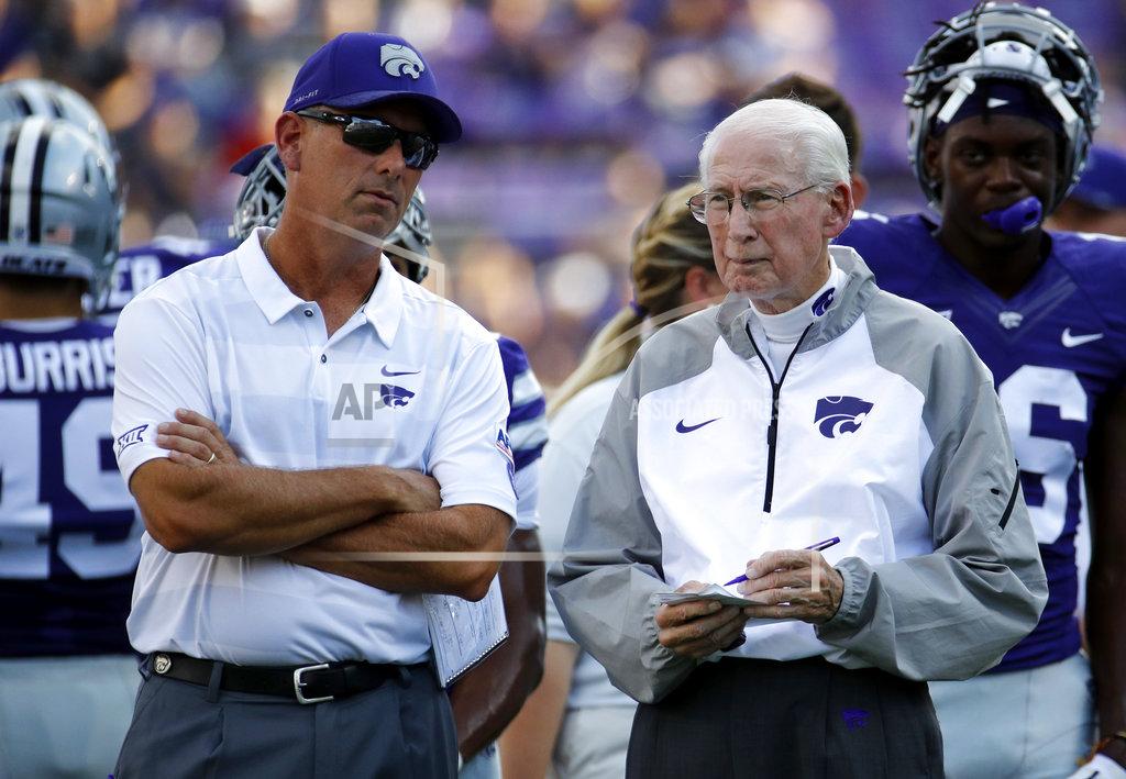 FILE - In this Sept. 1, 2018, file photo, Kansas State head coach Bill Snyder talks with his son and special teams coordinator Sean Snyder before an NCAA college football game against the South Dakota, in Manhattan, Kan. Snyder said again this week that he will evaluate after the season whether he will return next year, but there has been growing unrest in the program. Many believe that Snyder, who prefers that his son and special teams coordinator Sean eventually replaces him, will retire after this year. The question then becomes whether Snyder will get his wish.(AP Photo/Charlie Riedel, File)