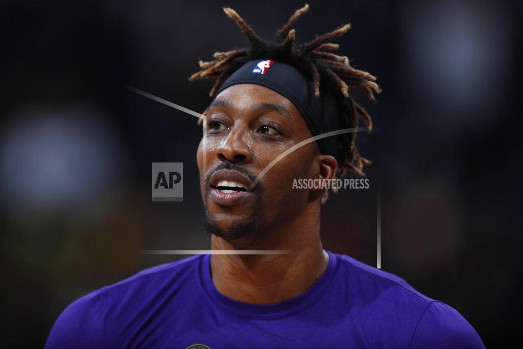 FILE - In this Feb. 12, 2020, file photo, Los Angeles Lakers center Dwight Howard looks on in the first half of an NBA basketball game against the Denver Nuggets in Denver. The mother of Howard's 6-year-old son died nearly six weeks ago due to an epileptic seizure, the Lakers center says. Howard has spent his hiatus from basketball dealing with the difficult task of explaining Melissa Rios' death to their son, but also grateful for the chance to heal from the loss outside the daily grind of the NBA schedule. (AP Photo/David Zalubowski, File)