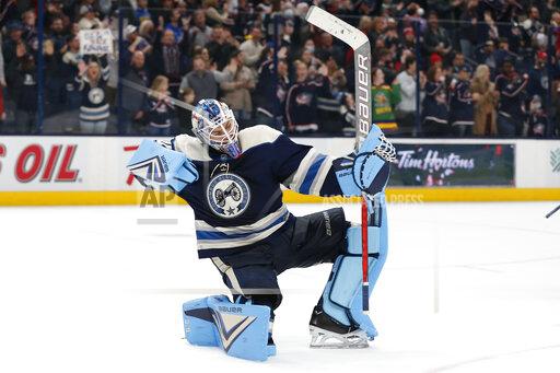Columbus Blue Jackets' Elvis Merzlikins celebrates his shut out against the Winnipeg Jets during the third period of an NHL hockey game Wednesday, Nov. 24, 2021, in Columbus, Ohio. (AP Photo/Jay LaPrete)