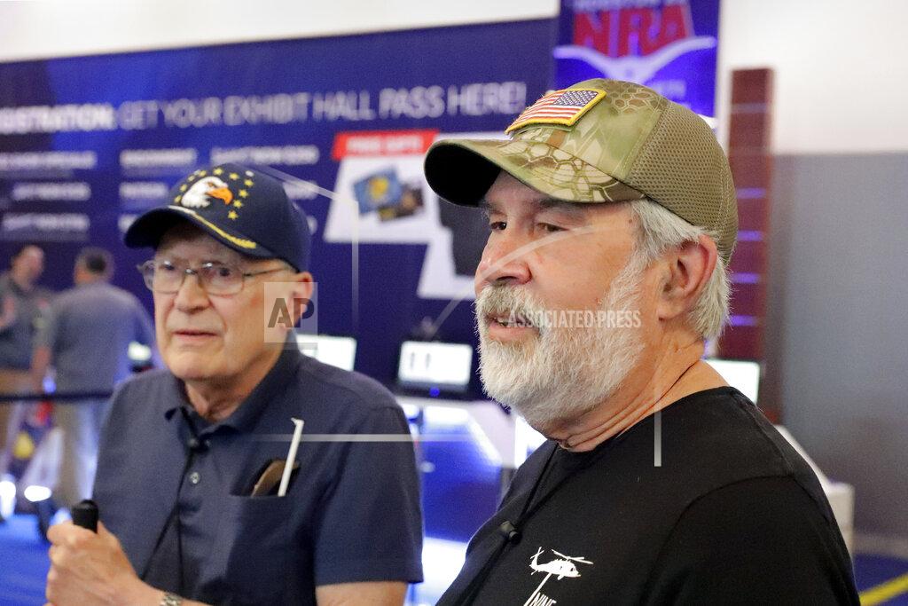 Michael Wyke Convention attendees Bill Galis, left, and Gary Francis, right, talks about their views of the current state of the NRA and the Uvalde school shooting, at the NRA Annual Meeting held at the George R. Brown Convention Center Thursday, May 26, 2022, in Houston. (AP Photo/Michael Wyke)