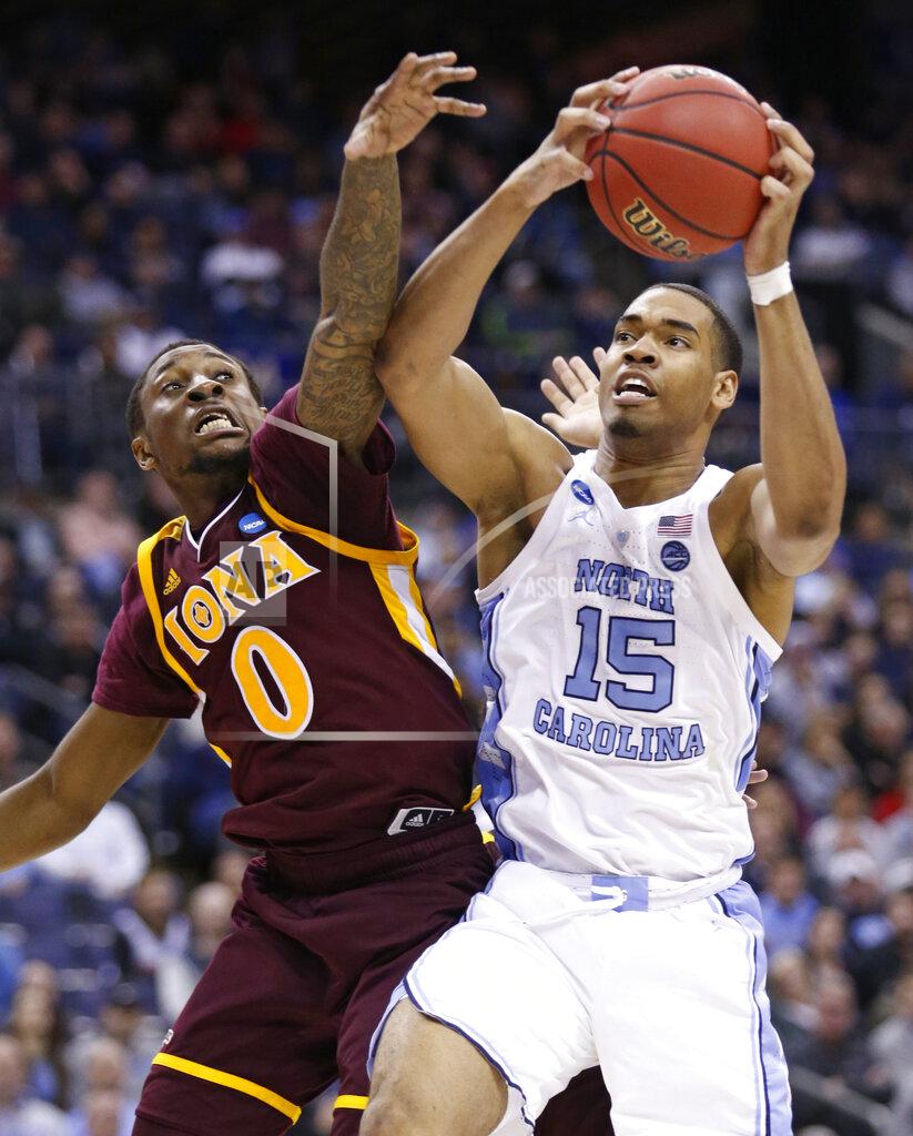 Paul Vernon North Carolina's Garrison Brooks (15) drives to the basket against Iona's Rickey McGill (0) during the second half of a first-round game in the NCAA men’s college basketball tournament in Columbus, Ohio, Friday, March 22, 2019. North Carolina won 88-73. (AP Photo/Paul Vernon)