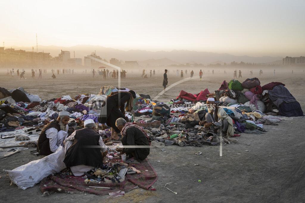 Bernat Armangue Afghans sort second-hand clothes at the Chaman-e-Hozari Park in Kabul, Afghanistan, Friday, Sept. 17, 2021. (AP Photo/Bernat Armangue)