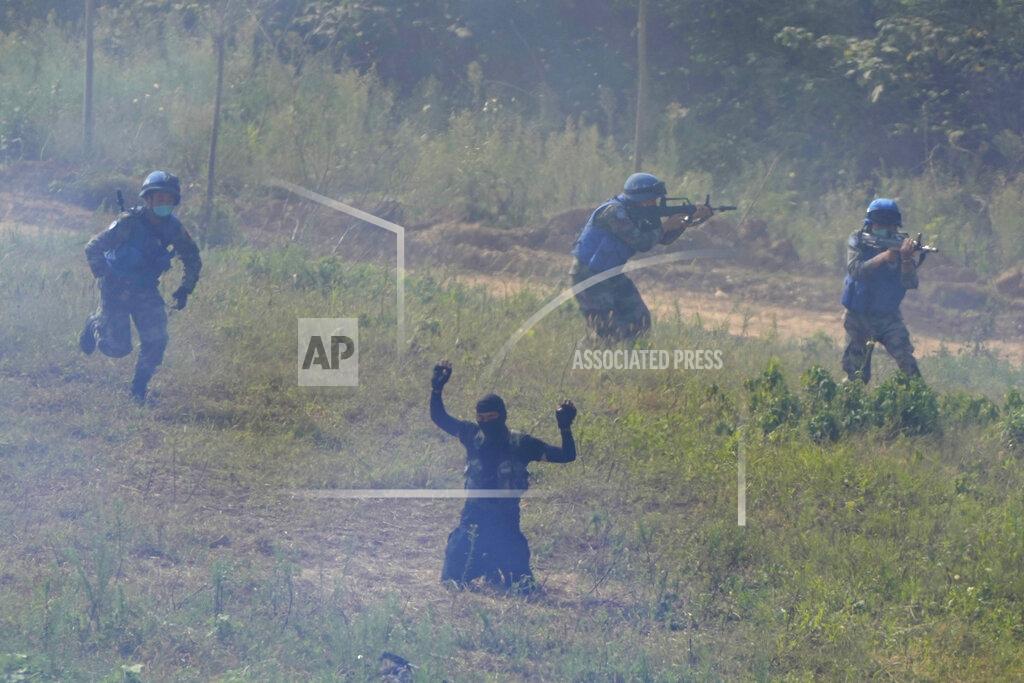 Ng Han Guan A participant playing the role of a terrorist surrenders after a failed attack on a United Nations base during the Shared Destiny 2021 drill at the Queshan Peacekeeping Operation training base in Queshan County in central China's Henan province Wednesday, Sept. 15, 2021. Peacekeeping troops from China, Thailand, Mongolia and Pakistan took part in the 10 days long exercise that field reconnaissance, armed escort, response to terrorist attacks, medical evacuation and epidemic control. (AP Photo/Ng Han Guan)
