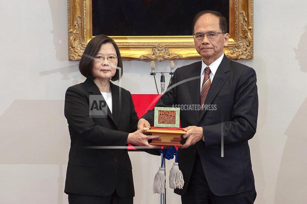Uncredited In this photo released by the Taiwan Presidential Office, Taiwanese President Tsai Ing-wen, left, holds up a seal with Parliament top speaker You Shi-kun during an inauguration ceremony at the Presidential office in Taipei, Taiwan on Wednesday, May 20, 2020. Tsai has been inaugurated for a second term amid increasing pressure from China on the self-governing island democracy it claims as its own territory. (Taiwan Presidential Office via AP)