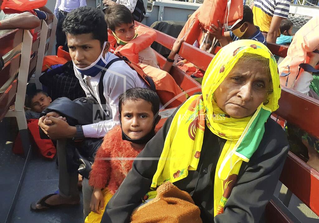 Saleh Noman Rohingya refugees board a ship as they are ferried to Bhashan Char, or floating island, in the Bay of Bengal, from Chittagong, Bangladesh, Friday, Dec. 4, 2020. Authorities in Bangladesh on Friday started sending a first group of nearly more than 1,500 Rohingya refugees to an isolated island despite calls by human rights groups for a halt to the process. (AP Photo/Saleh Noman)
