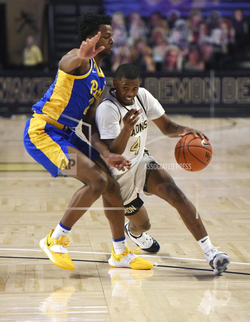 Walt Unks Wake Forest's Daivien Williamson drives the lane against Pittsburgh's Femi Odukale (2) during an NCAA college basketball game Saturday, Jan. 23, 2021, in Winston-Salem, N.C. (Walt Unks/The Winston-Salem Journal via AP)
