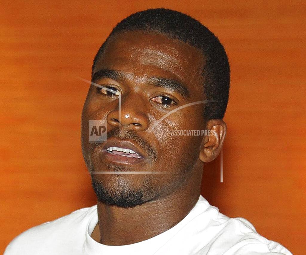 FILE — In this file photo taken Tuesday Oct. 14, 2014, South African soccer captain Senzo Meyiwa, is photographed in Johannesburg. Six years and one day since Meyiwa was fatally shot at his celebrity girlfriend's house, five men accused of being part of a plot to assassinate him in an organized "hit" appeared in a courtroom Tuesday, Oc. 27, 2020, only for the case to be beset again by confusion and doubt. (AP Photo/File)