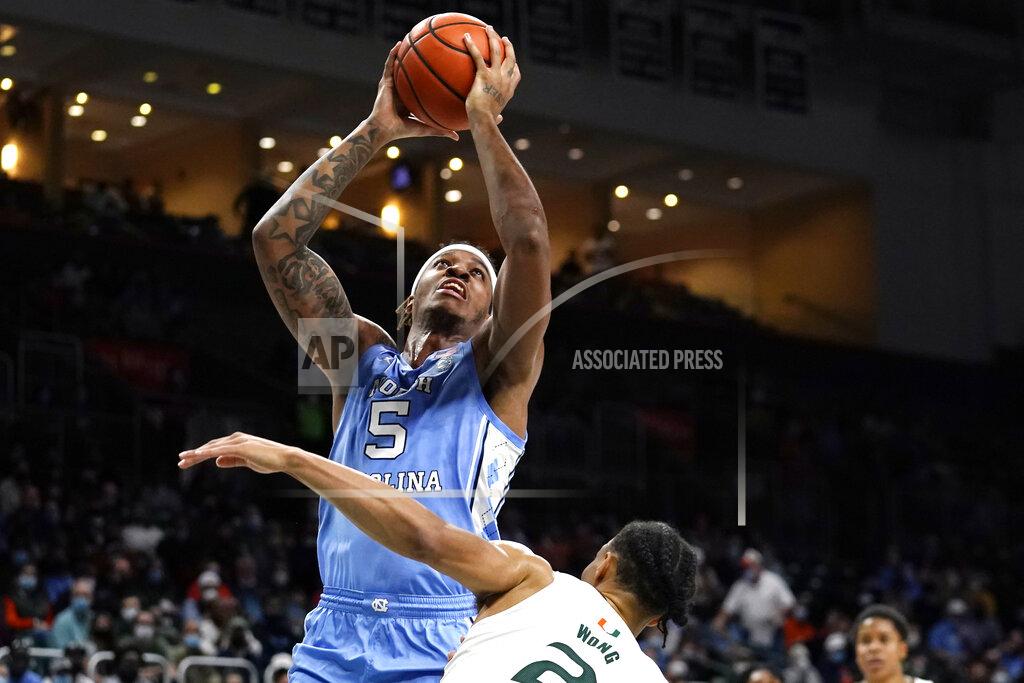 Lynne Sladky North Carolina forward Armando Bacot (5) shoots over Miami guard Isaiah Wong (2) during the first half of an NCAA college basketball game, Tuesday, Jan. 18, 2022, in Coral Gables, Fla. (AP Photo/Lynne Sladky)