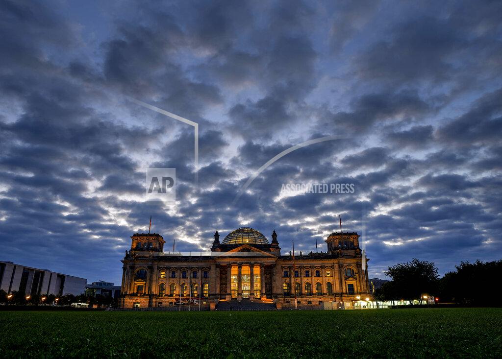 Michael Probst File-In Sept. 26, 2021 taken photo clouds drift over the Reichstag building with the German parliament in Berlin. The parliament gather for the first plenary session after the elections. (AP Photo/Michael Probst)