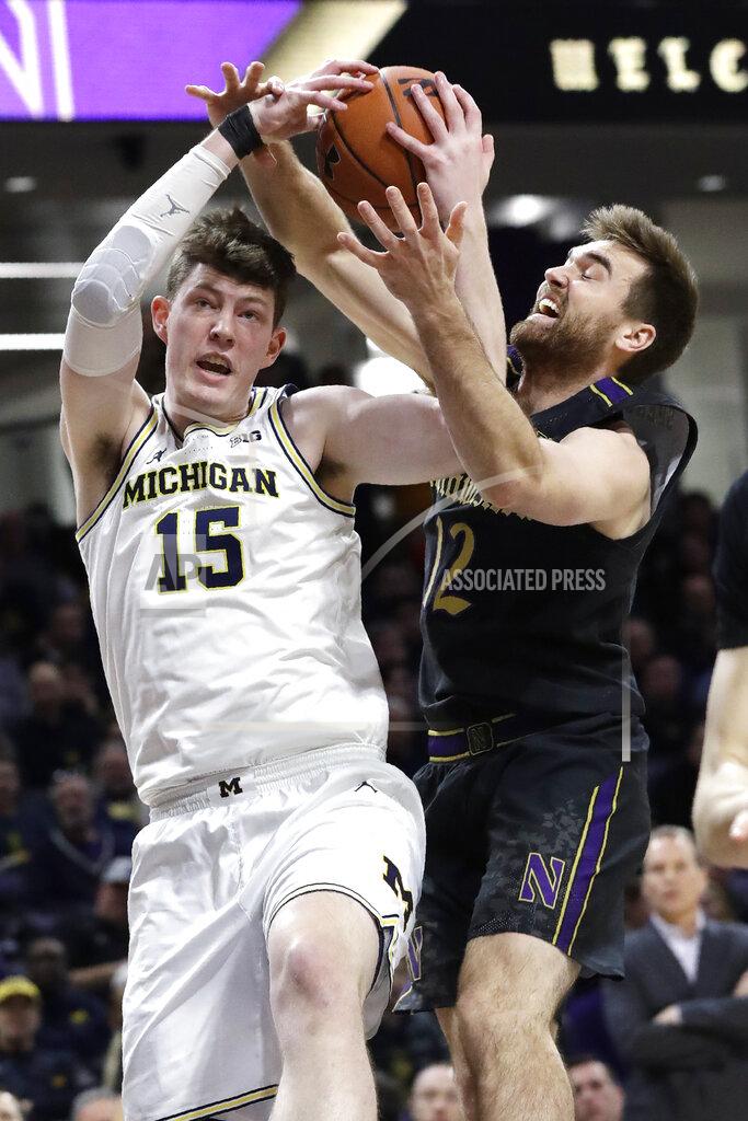 Nam Y. Huh Michigan center Jon Teske, left, rebounds against Northwestern guard Pat Spencer during the first half of an NCAA college basketball game in Evanston, Ill., Wednesday, Feb. 12, 2020. (AP Photo/Nam Y. Huh)