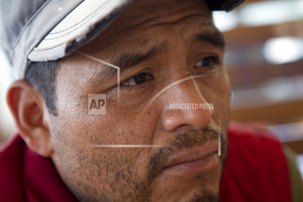 Oliver De Ros Mynor Cardona, Yenifer Yulisa Cardona Tomás' father, listens to a question during an interview in Guatemala City, Monday, July 4, 2022. Yenifer Yulisa Cardona Tomás is one of the survivors of the more than 50 migrants who were found dead inside a tractor-trailer near San Antonio, Texas. (AP Photo/Oliver de Ros)