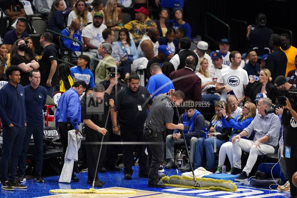 Tony Gutierrez American Airlines Center employees mop up rain that was leaking from the roof during the second half of Game 4 of the NBA basketball playoffs Western Conference finals between the Dallas Mavericks and the Golden State Warriors, Tuesday, May 24, 2022, in Dallas. (AP Photo/Tony Gutierrez)