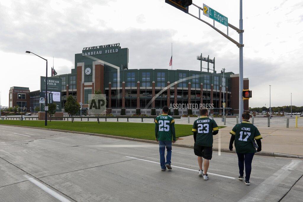 Mike Roemer Fans walk on the street outside Lambeau Field before an NFL football game between the Green Bay Packers and the Detroit Lions Sunday, Sept. 20, 2020, in Green Bay, Wis. (AP Photo/Mike Roemer)