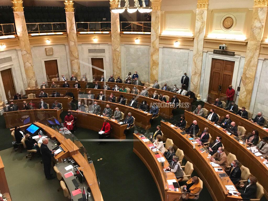Gov. Asa Hutchinson delivers his State of the State address to lawmakers in the House chamber of the state Capitol in Little Rock, Ark., on Tuesday, Jan. 12, 2021. Hutchinson urged lawmakers to support the emergency he's declared in response to the coronavirus pandemic and to enact hate crimes legislation. (AP Photo/Andrew Demillo)