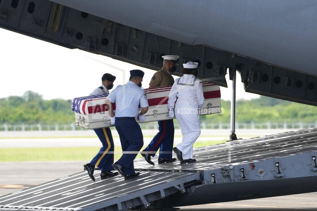 Sakchai Lalit U.S. military carry the possible remains of a WWII U.S. airman found in northern Thailand to a waiting C-17 during a repatriation ceremony Wednesday, May 18, 2022, at the U-Tapao Air Base in Rayong province, eastern Thailand. The possible human remains were found at a crash site in a rice field in northern Thailand by the Defense POW/MIA Accounting Agency and were sent to Hawaii where they will be tested to see if they belong to a U.S. pilot who went missing in 1944. (AP Photo/Sakchai Lalit)