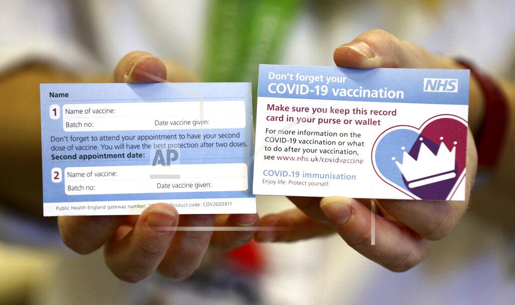 Gareth Fuller Both sides of a record card are displayed, that will be given to all recipients of the Pfizer coronavirus vaccine, at Croydon University Hospital Saturday Dec. 5, 2020. The Croydon University Hospital has taken delivery of the first batch of Pfizer COVID-19 vaccine in preparation or a public inoculation program, with each person needing two injections and the vaccine stored at extremely low temperature. (Gareth Fuller/Pool via AP)