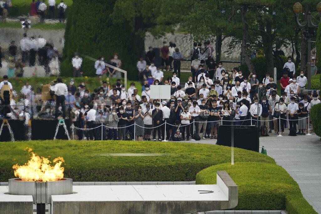 Eugene Hoshiko Visitors observe a minute of silence for the victims of the atomic bombing, at 8:15am, the time atomic bomb exploded over the city, at the Hiroshima Peace Memorial Park during the ceremony to mark the 75th anniversary of the bombing Thursday, Aug. 6, 2020, in Hiroshima, western Japan. (AP Photo/Eugene Hoshiko)