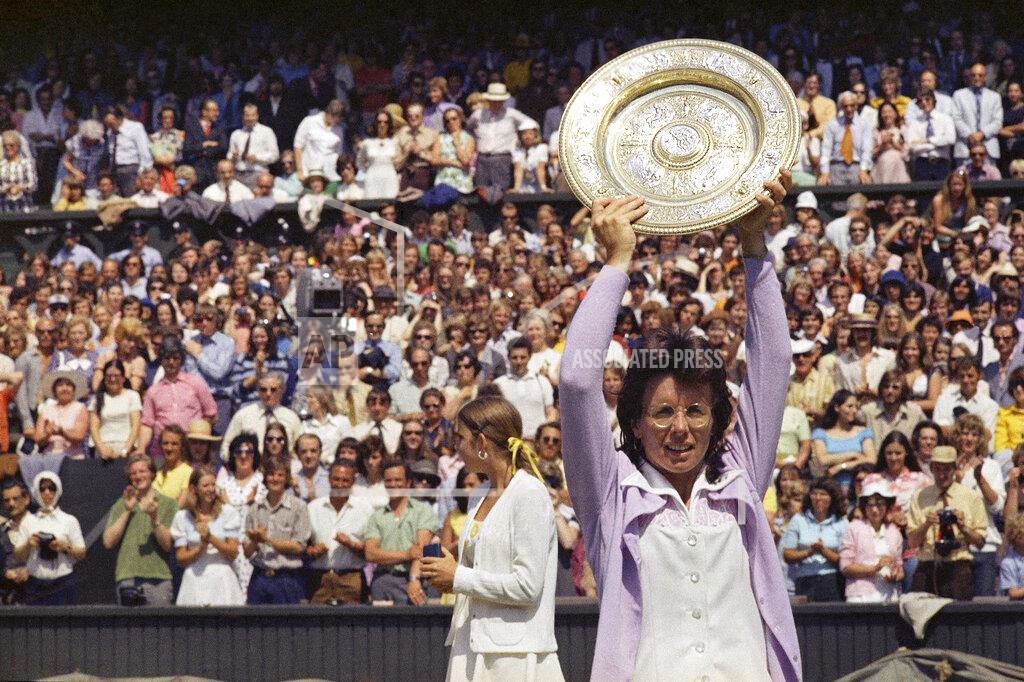 Uncredited FILE - In this July 7, 1973, file photo, Billie Jean King holds up the championship trophy after defeating Chris Evert in the Wimbledon women's singles final in London. This was King's fifth time winning Wimbledon. (AP Photo/File)