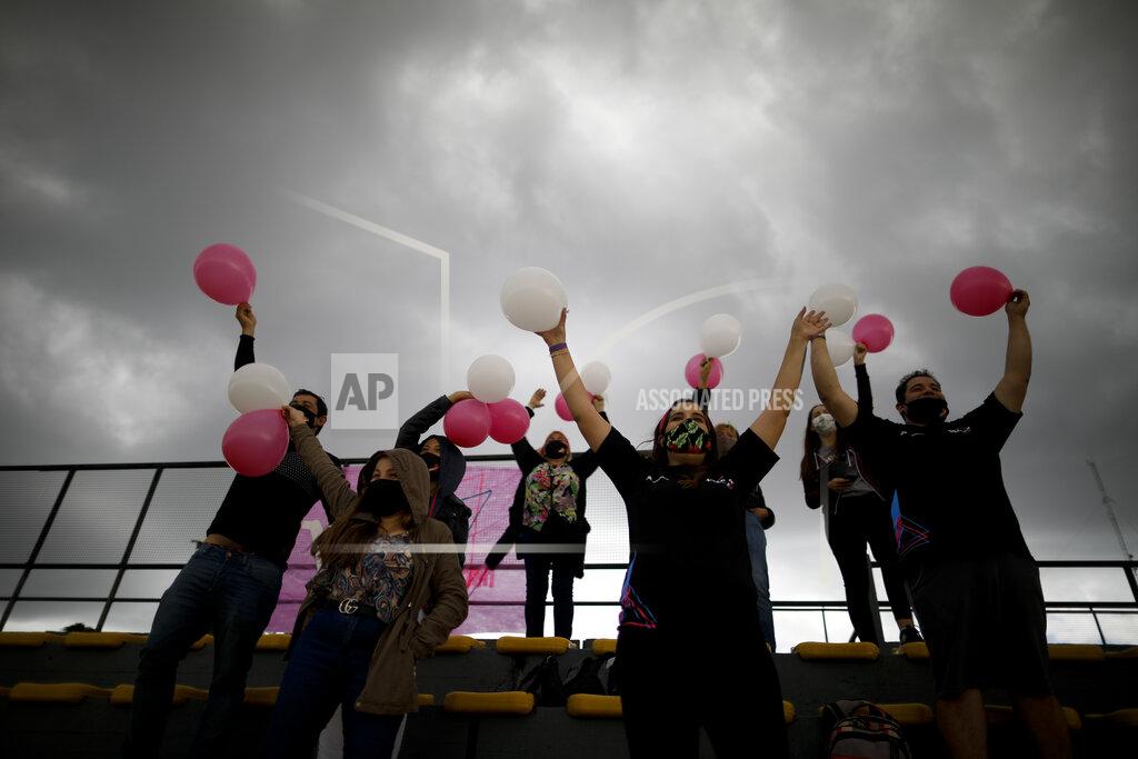 Natacha Pisarenko Vitarti Girl's Team fans cheer from the stands during the team's first race at the Oscar y Juan Galvez track in Buenos Aires, Argentina, Sunday, April 4, 2021. Finding sponsors has been difficult for the Vitarti Girl’s Team, the first and only all-female racing team in Argentina, and they only have enough funds in the budget for two more races. (AP Photo/Natacha Pisarenko)