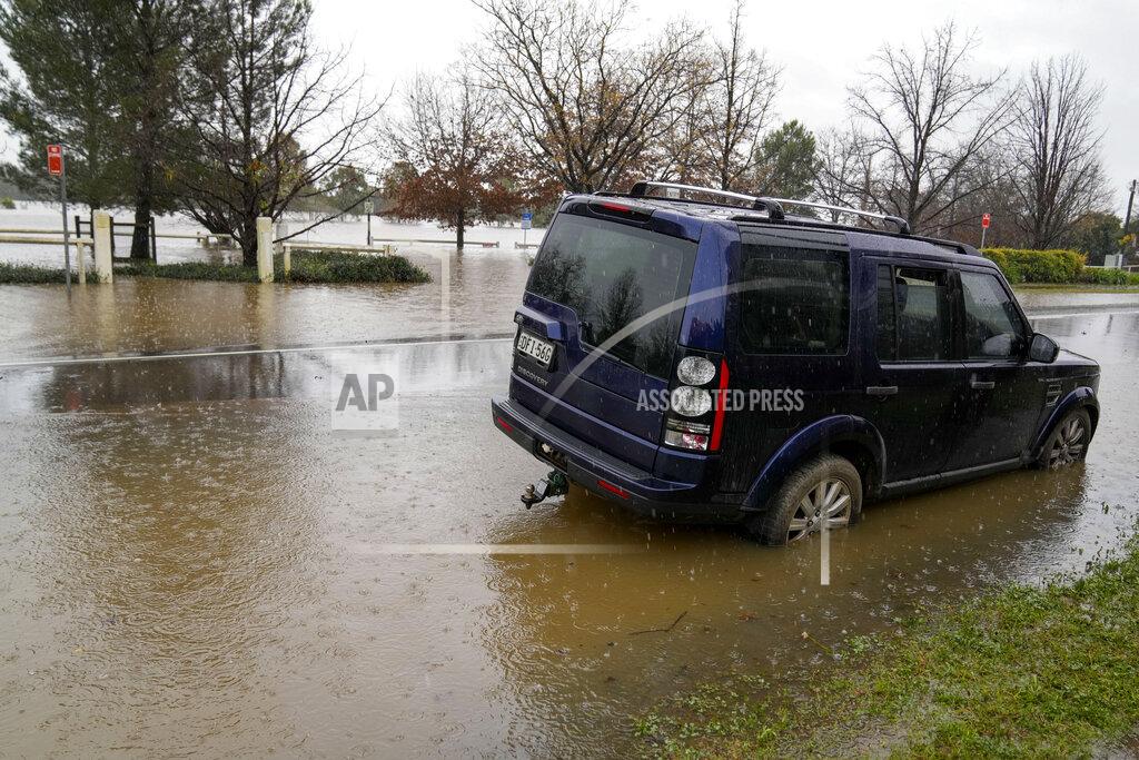 Mark Baker A car sits semi-submerged in flood waters at Camden on the outskirts of Sydney, Australia, Monday, July 4, 2022. More than 30,000 residents of Sydney and its surrounds have been told to evacuate or prepare to abandon their homes on Monday as Australia’s largest city braces for what could be its worst flooding in 18 months. (AP Photo/Mark Baker)