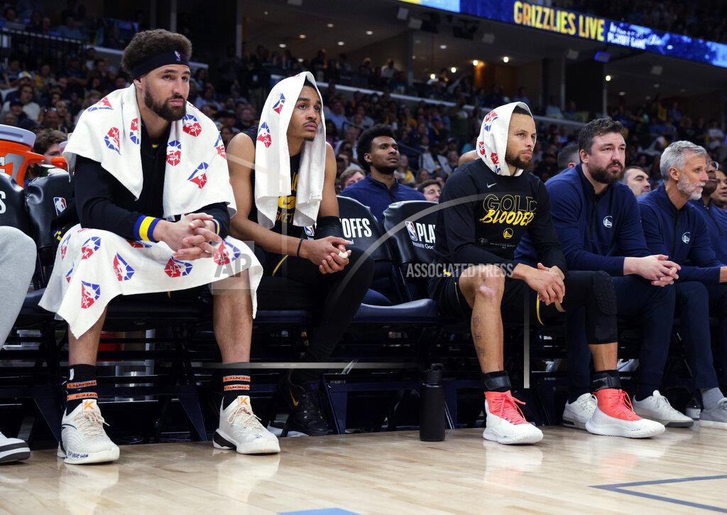 Carlos Avila Gonzalez Golden State Warriors Klay Thompson (11), Jordan Poole (3), and Stephen Curry (30) watch from the bench during the second half of Game 5 of an NBA basketball second-round playoff series against the Memphis Grizzlies, Wednesday, May 11, 2022, in Memphis, Tenn. (Carlos Avila Gonzalez/San Francisco Chronicle via AP)