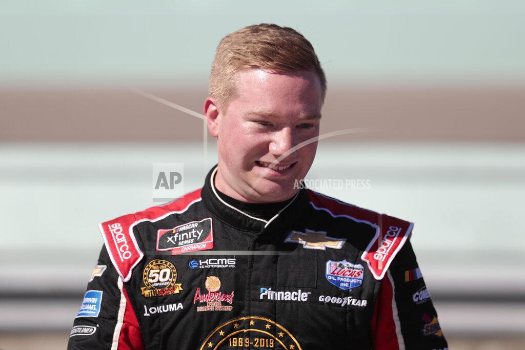 Luis M. Alvarez Tyler Reddick poses is seen in the pits after winning the pole position for the NASCAR Xfinity Series auto racing championship at Homestead-Miami Speedway in Homestead, Fla. Saturday, Nov. 16, 2019. (AP Photo/Luis M. Alvarez)