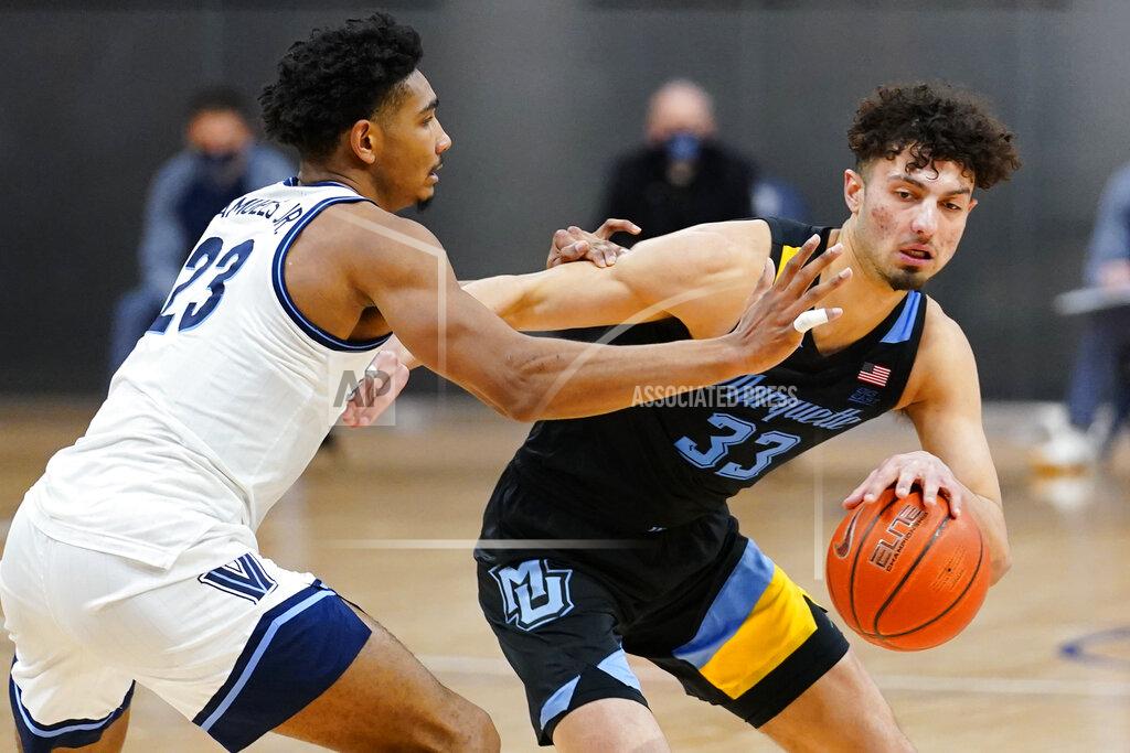 Matt Slocum Marquette's Dawson Garcia (33) tries to drive past Villanova's Jermaine Samuels (23) during the second half of an NCAA college basketball game, Wednesday, Feb. 10, 2021, in Villanova, Pa. (AP Photo/Matt Slocum)