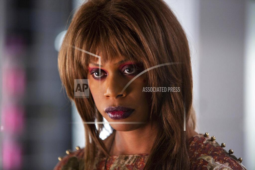 Tobin Yellan This image released by Hulu shows Laverne Cox in a scene from "Bad Hair," a comedy-horror about woman trying to rise in the late-80s music business who gets a demonic weave. The film premieres Friday on Hulu. (Tobin Yellan/Hulu via AP)