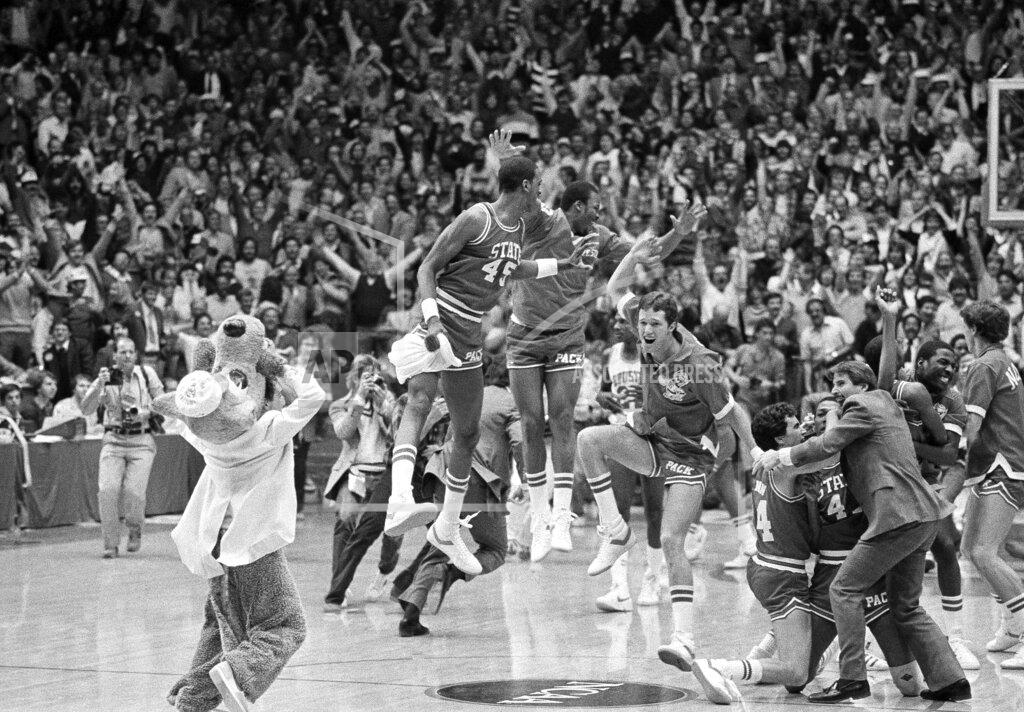 Anonymous FILE - In this April 4, 1983, file photo, a high jumping Cozell McQueen (45), left center, and teammates celebrate defeating Houston 54-52 in the NCAA college basketball championship game in Albuquerque, N.M. (AP Photo/File)