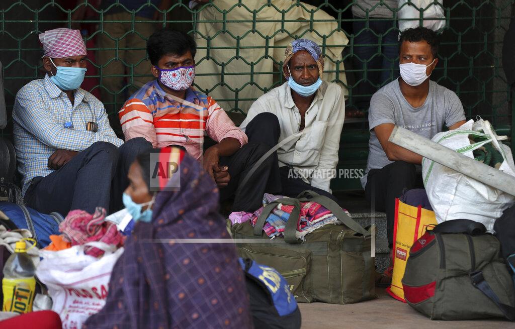 Aijaz Rahi Travelers wait for outstation trains after authorities imposed a two-week lockdown to curb the rising number of COVID-19 cases in Bengaluru, India, Wednesday, April 28, 2021. India, a country of nearly 1.4 billion people, Wednesday became the fourth nation to cross 200,000 deaths. (AP Photo/Aijaz Rahi)