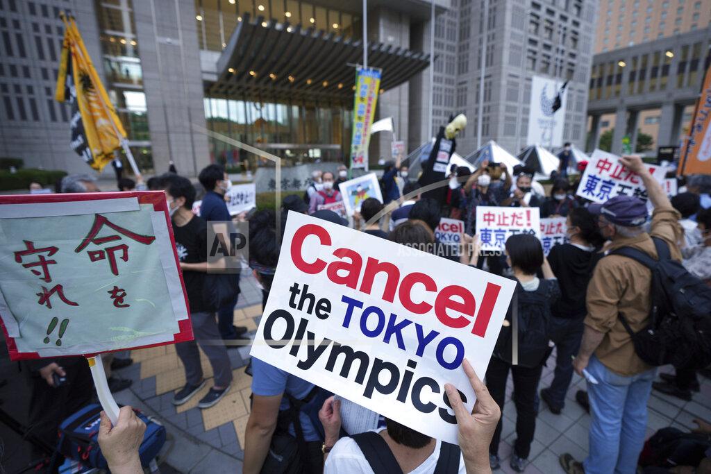 FILE - In this June 23, 2021, file photo, people against the 2020 Summer Olympics, gather to protest around the Tokyo Metropolitan Government building during a demonstration in Tokyo. (AP Photo/Eugene Hoshiko, File)
