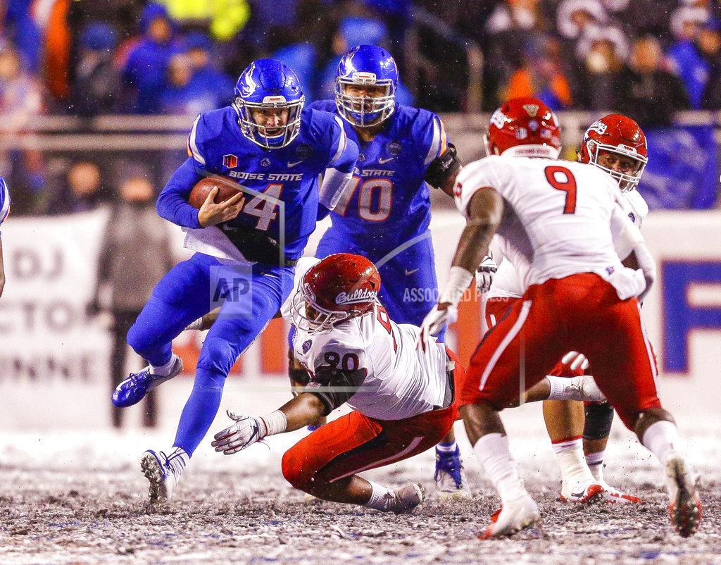 Steve Conner Boise State quarterback Brett Rypien (4) scrambles by Fresno State defensive tackle Kevin Atkins (90) the second half of an NCAA college football game for the Mountain West championship Saturday, Dec. 1, 2018, in Boise, Idaho. Fresno State won 19-16. (AP Photo/Steve Conner)