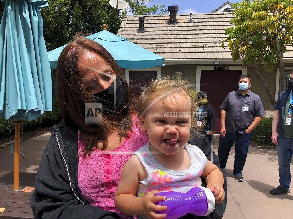 Julie Watson Lindsey Prescott looks at her 18-month-old daughter, Mia, as she giggles on Tuesday, May 11, 2021 in San Diego. Prescott moved into a converted San Diego hotel that Gov. Gavin Newsom visited Tuesday to announce a $12 billion program to get people like Prescott off the streets. (AP Photo/Julie Watson)