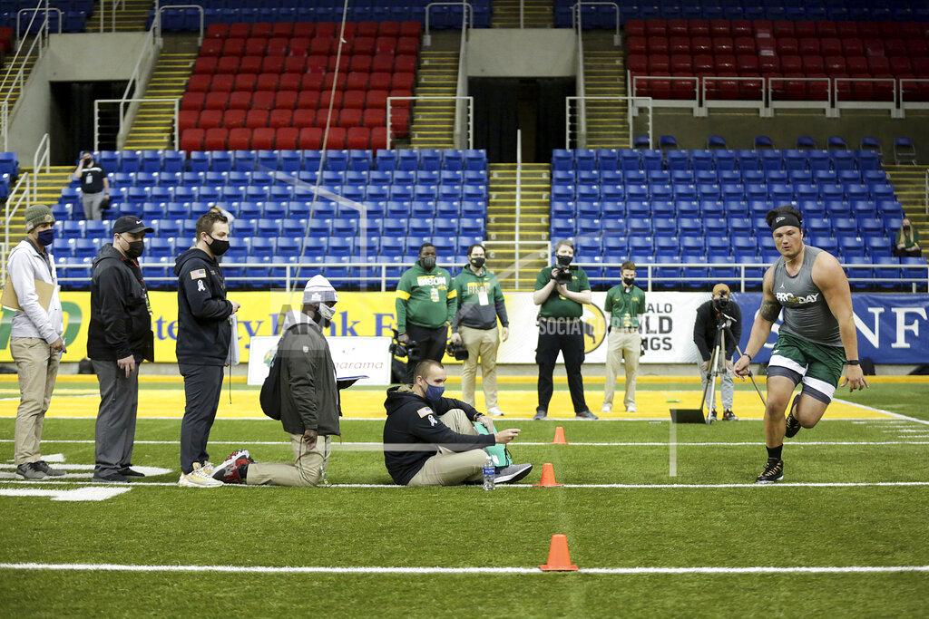 Andy Clayton-King NFL scouts watch as North Dakota State lineman Dillon Radunz does drills at the school's football NFL Pro Day Friday, March, 12, 2021, in Fargo, North Dakota. (AP Photo/Andy Clayton- King)