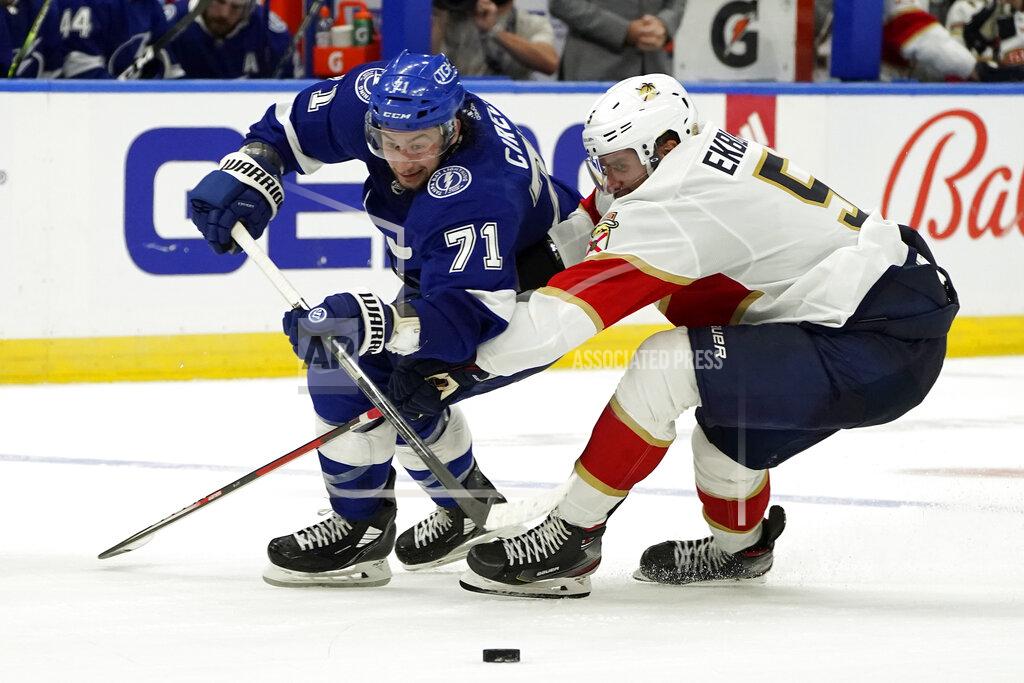 Chris O'MEara Tampa Bay Lightning center Anthony Cirelli (71) is held up by Florida Panthers defenseman Aaron Ekblad (5) during the second period of an NHL hockey game Tuesday, Oct. 19, 2021, in Tampa, Fla. (AP Photo/Chris O'Meara)