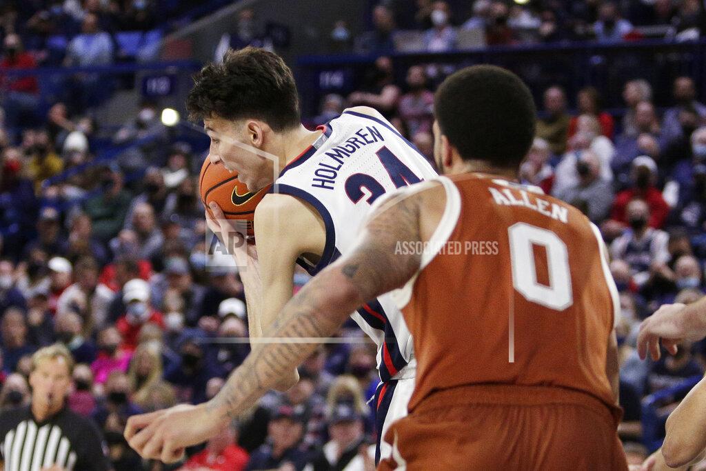 Young Kwak Gonzaga center Chet Holmgren, left, secures a rebound in front of Texas forward Timmy Allen during the second half of an NCAA college basketball game, Saturday, Nov. 13, 2021, in Spokane, Wash. Gonzaga won 86-74. (AP Photo/Young Kwak)