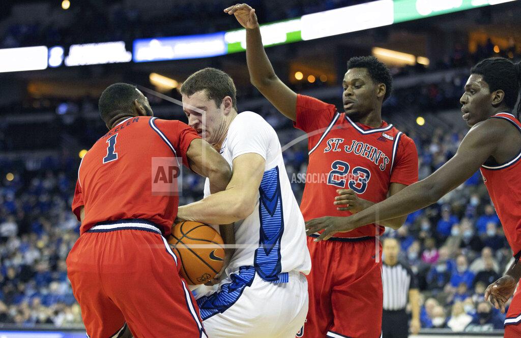 Rebecca S. Gratz Creighton's Ryan Kalkbrenner (11) battles to maintain possession of the ball against St. John's Aaron Wheeler (1), Montez Mathis (23) and O'Mar Stanley, right, during the first half of an NCAA college basketball game Wednesday, Jan. 19, 2022, in Omaha, Neb. (AP Photo/Rebecca S. Gratz)