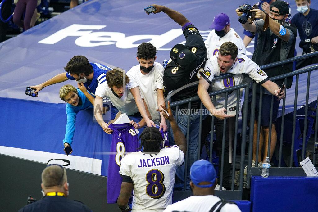 Darron Cummings Fans try for photos and autographed as Baltimore Ravens quarterback Lamar Jackson (8) leaves the field following an NFL football game against the Indianapolis Colts in Indianapolis, Sunday, Nov. 8, 2020. The Ravens defeated the Colts 24-10. (AP Photo/Darron Cummings)