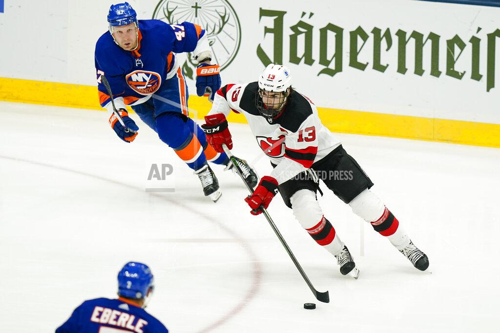 Frank Franklin Ii New Jersey Devils' Nico Hischier (13) drives past New York Islanders' Leo Komarov (47) and Jordan Eberle during the first period of an NHL hockey game Saturday, May 8, 2021, in Uniondale, N.Y. (AP Photo/Frank Franklin II)
