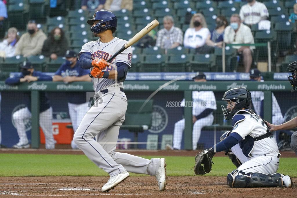 Ted S. Warren Houston Astros' Taylor Jones watches his RBI single next to Seattle Mariners catcher Luis Torrens during the fourth inning of a baseball game Saturday, April 17, 2021, in Seattle. Michael Brantley scored. (AP Photo/Ted S. Warren)
