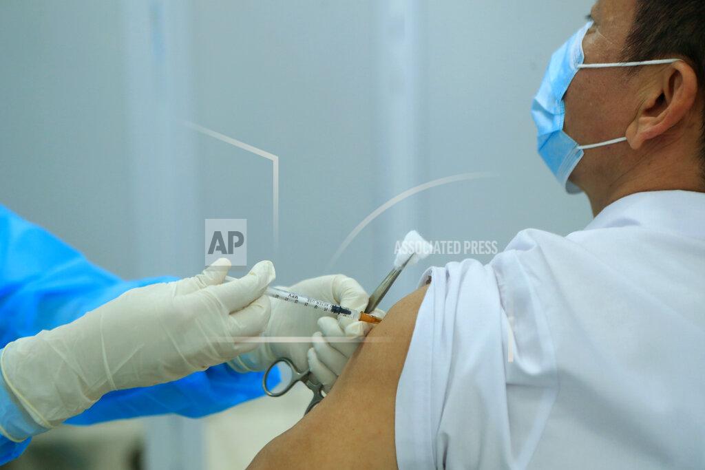Hau Dinh A health worker injects a doctor with a dose of AstraZeneca COVID-19 vaccine at Hospital for Tropical Diseases in Hanoi, Vietnam Monday, March 8, 2021. Vietnam has started the vaccination campaign with a hope to inoculate half of the population of 96 millions against COVID-19 by the end of the year. (AP Photo/Hau Dinh)