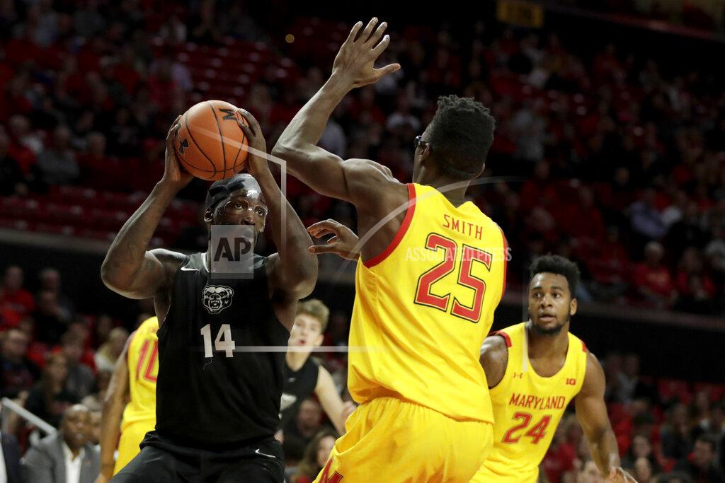 Julio Cortez Oakland forward Xavier Hill-Mais (14) goes up for a shot against Maryland forward Jalen Smith (25) during the first half of an NCAA college basketball game, Saturday, Nov. 16, 2019, in College Park, Md. (AP Photo/Julio Cortez)