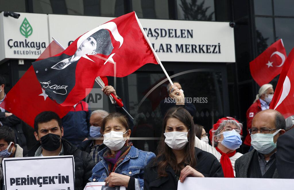 Burhan Ozbilici People wearing masks to help protect against the spread of coronavirus, attend a protest outside the US embassy, in Ankara, Turkey, Monday, April 26, 2021. Turkey's President Recep Tayyip Erdogan has announced the country's strictest pandemic restrictions so far, closing businesses and schools and limiting travel for nearly three weeks starting Thursday to fight a surge in COVID-19 infections and deaths. (AP Photo/Burhan Ozbilici)