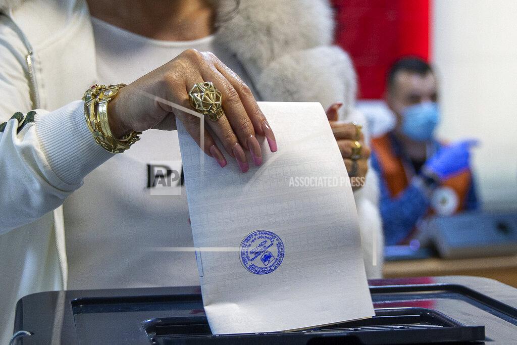 Visar Kryeziu A woman casts her ballot during parliamentary elections in capital Tirana, Albania, Sunday, April 25, 2021. Albanians are voting in parliamentary elections amid the virus pandemic and a bitter political rivalry between the two largest political parties. (AP Photo/Visar Kryeziu)